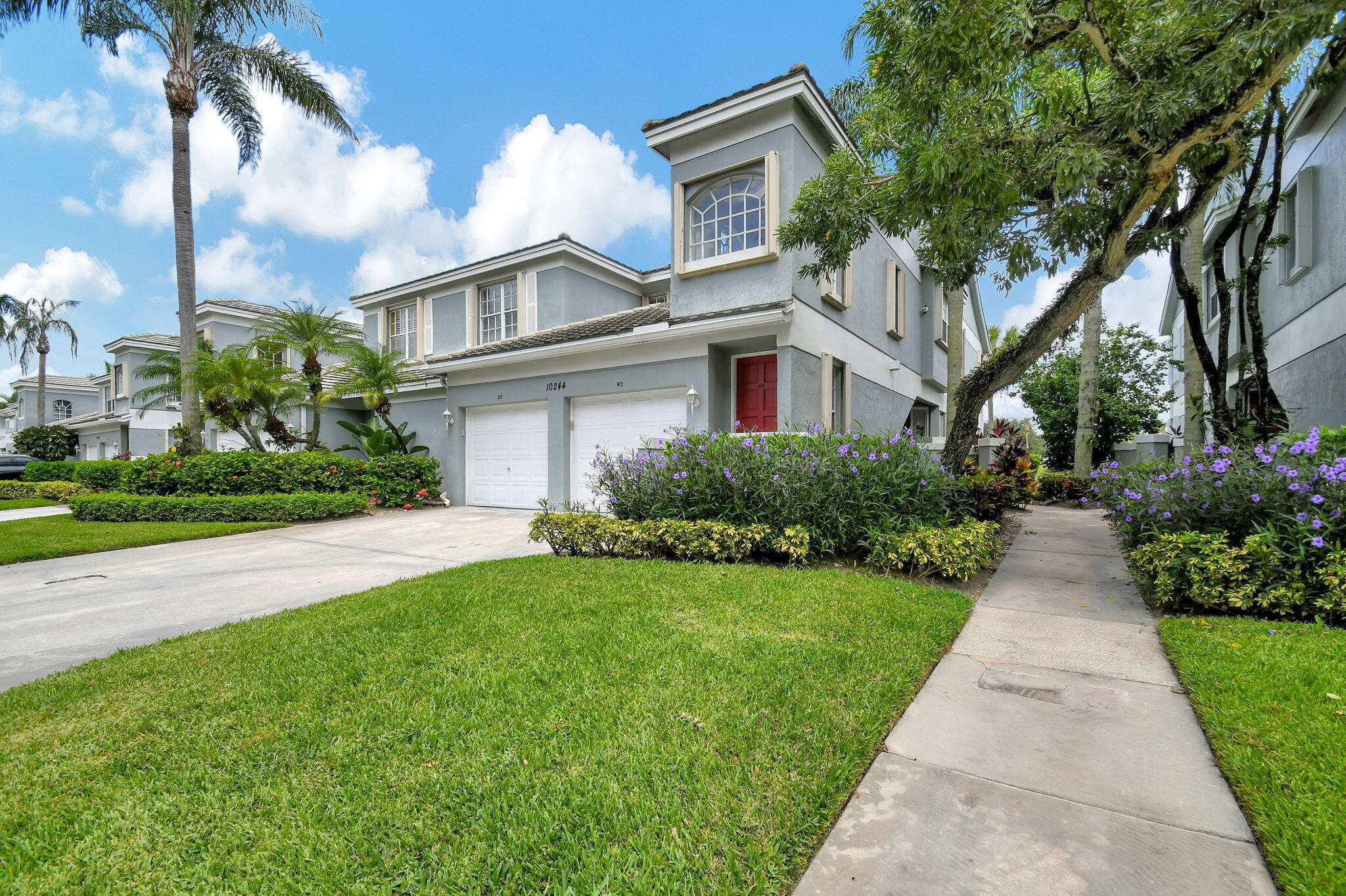 a front view of house with yard and green space