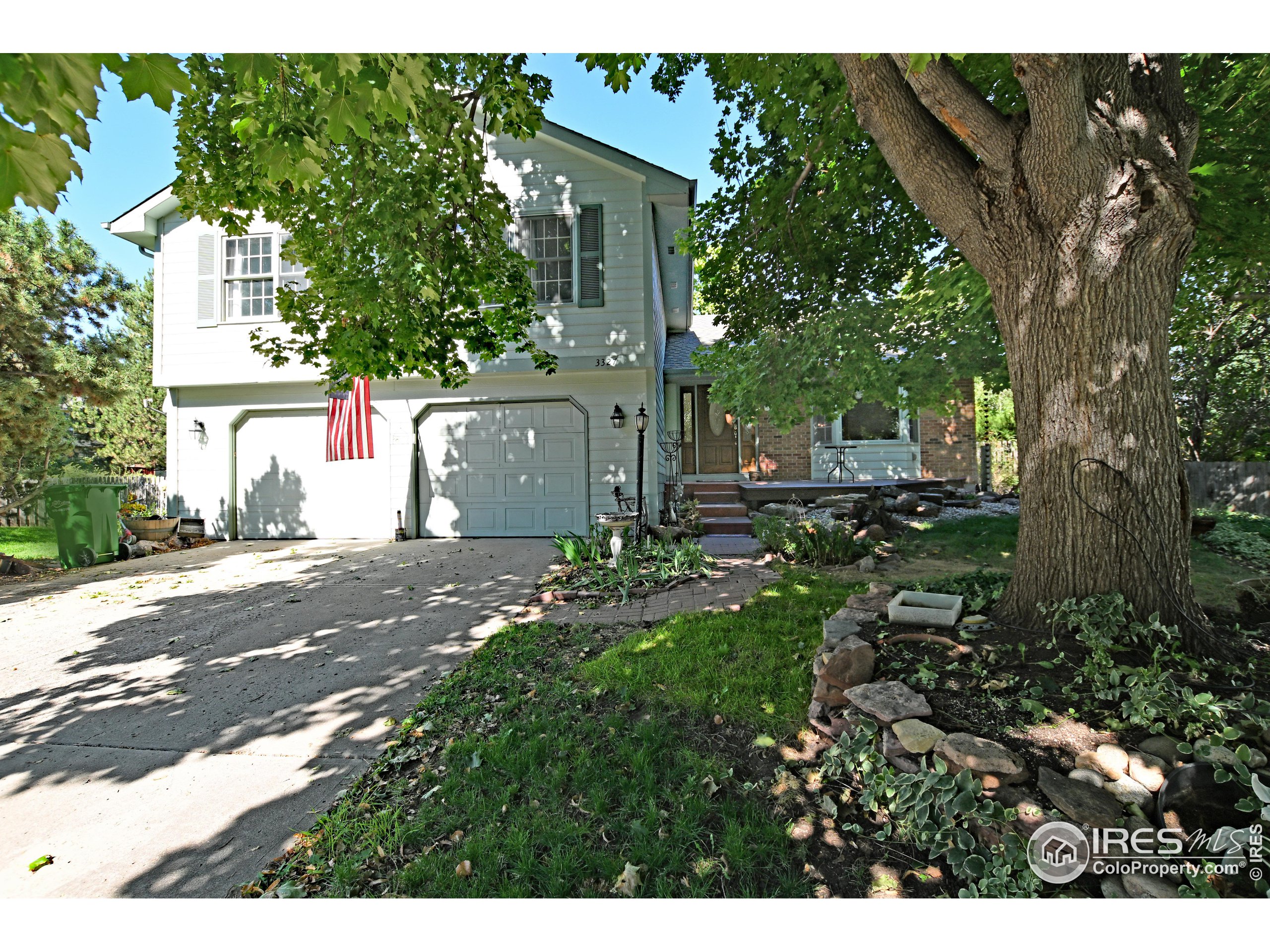 a view of a house with a tree in the background