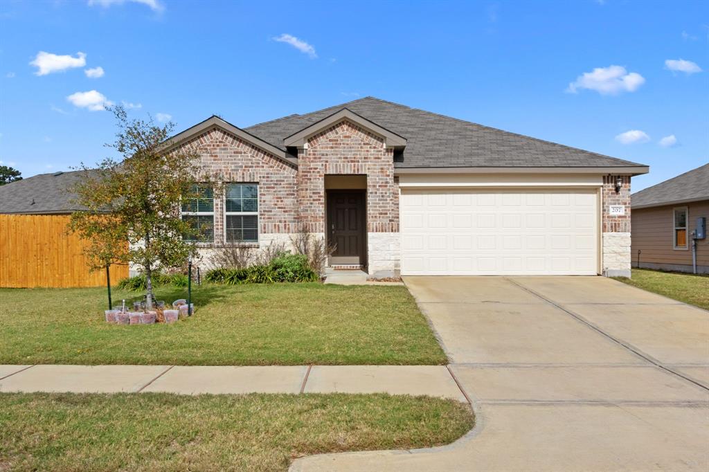 a front view of a house with a yard and garage