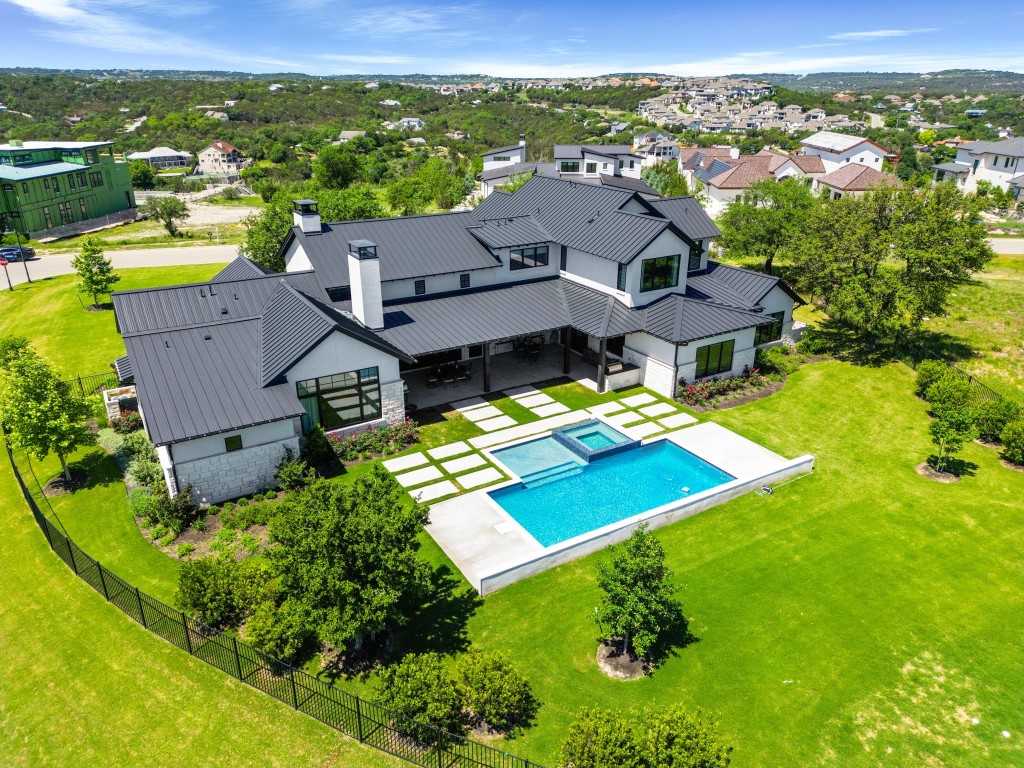 an aerial view of residential houses with outdoor space and city view