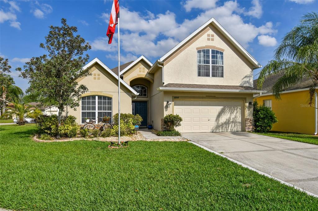 a front view of a house with a yard and garage