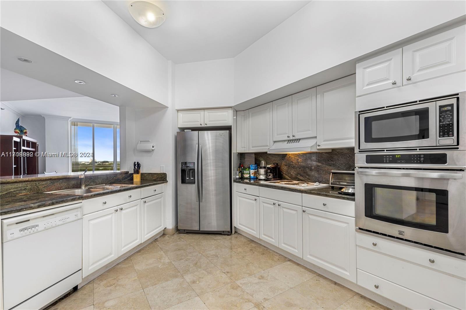 a kitchen with a sink stove and refrigerator