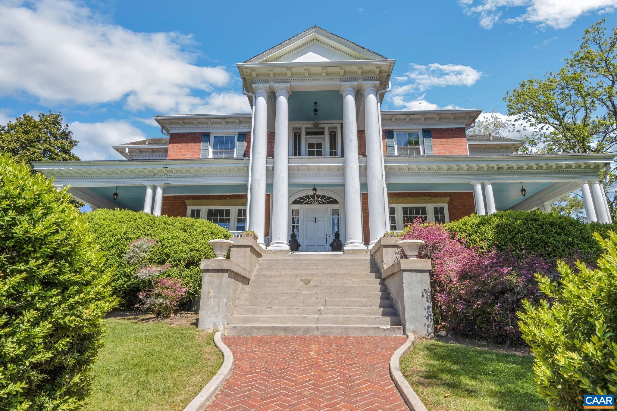 front view of a brick house with a yard