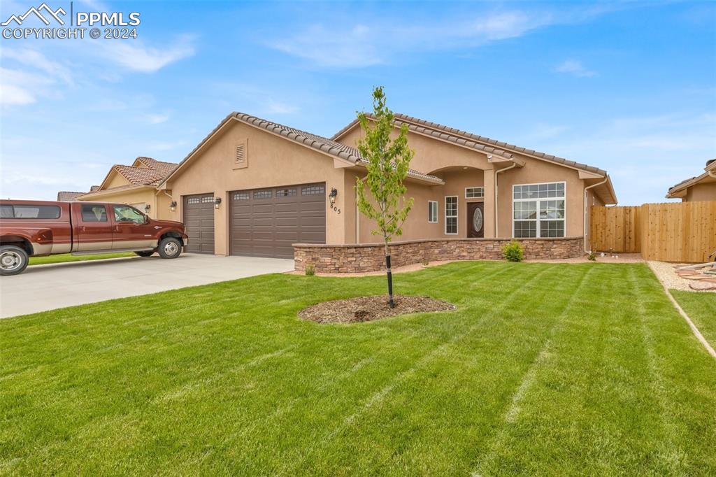 a front view of house with yard and green space