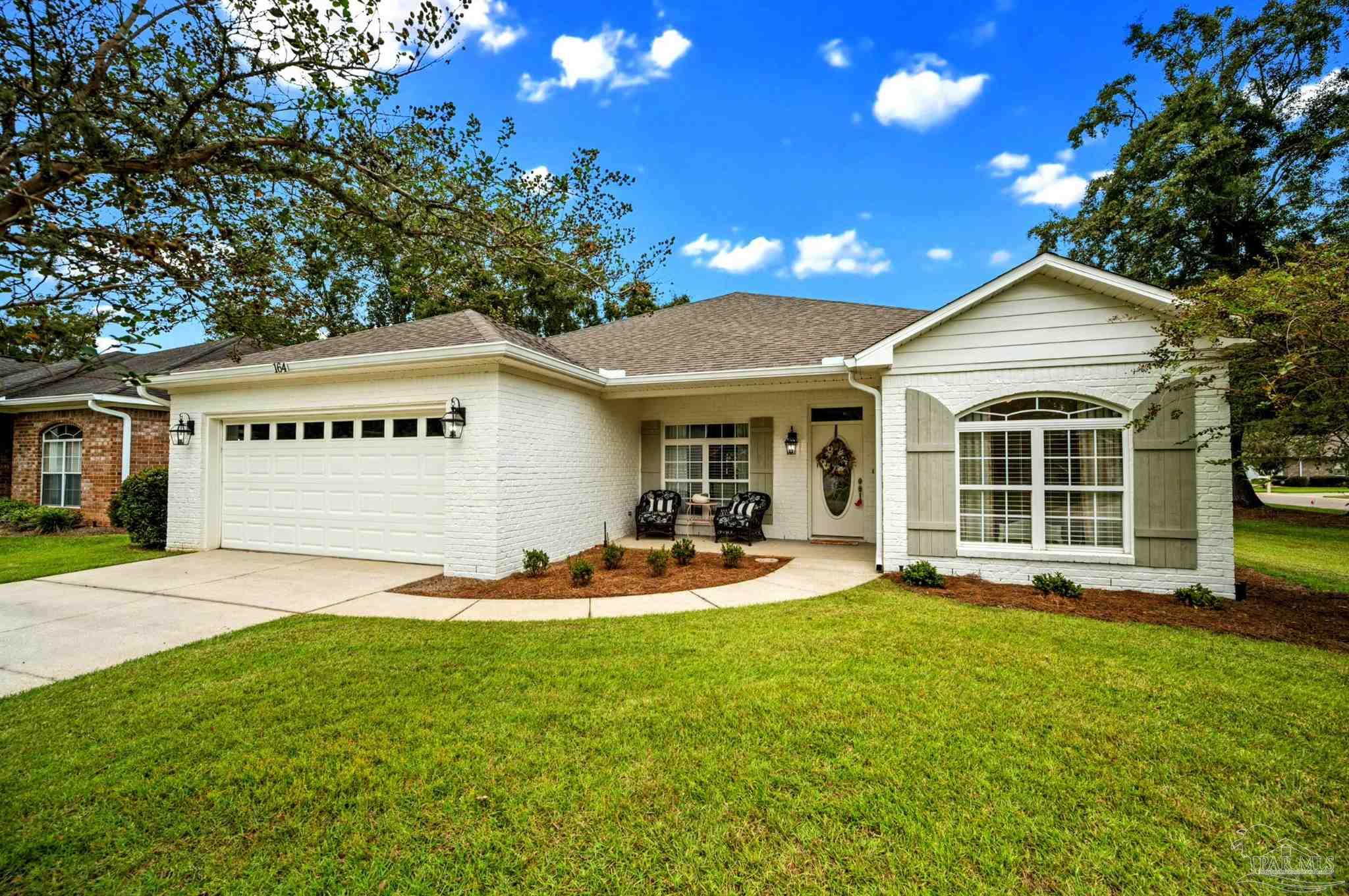 a front view of a house with a yard and porch