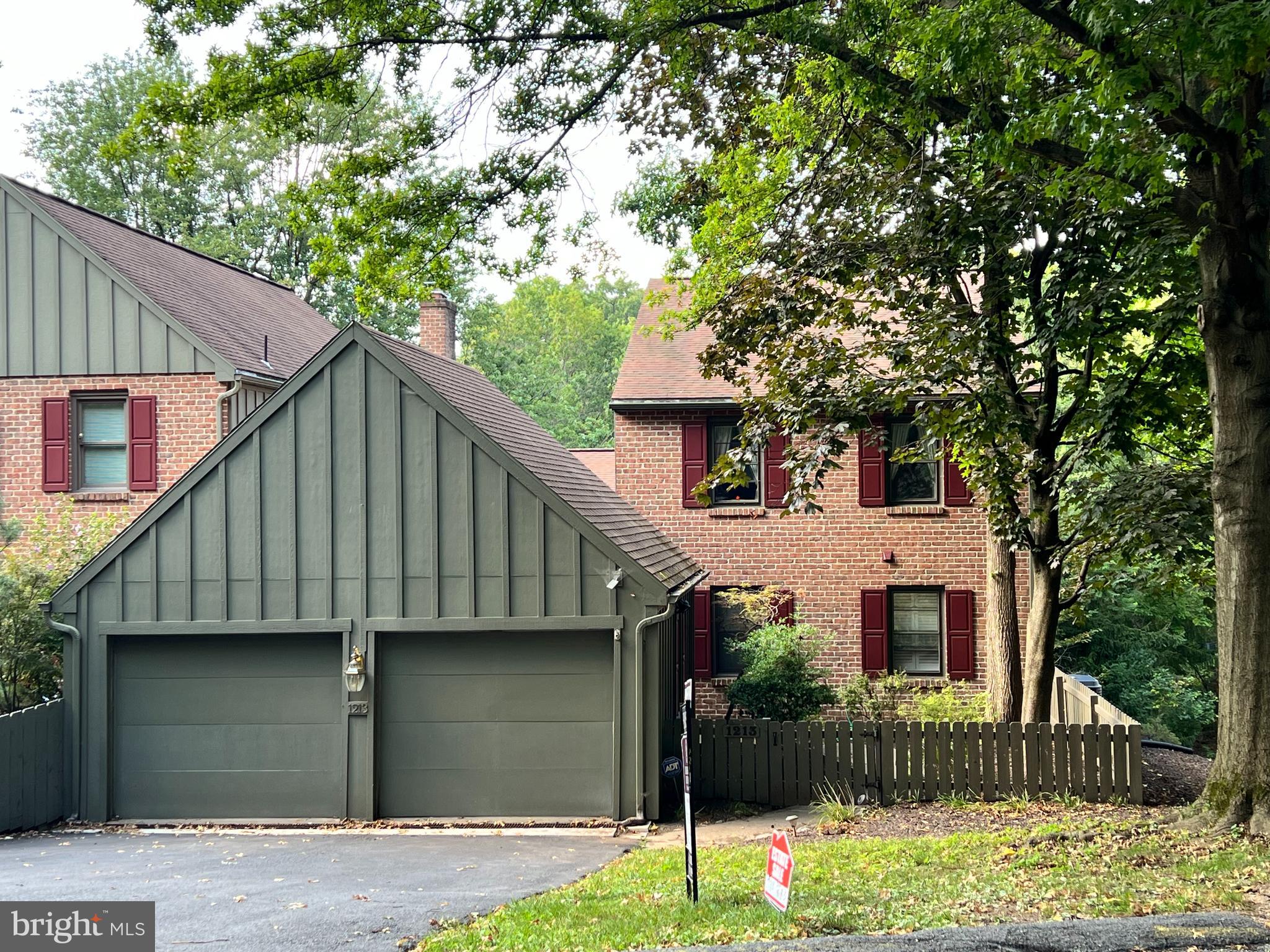 a house that has a tree in front of it