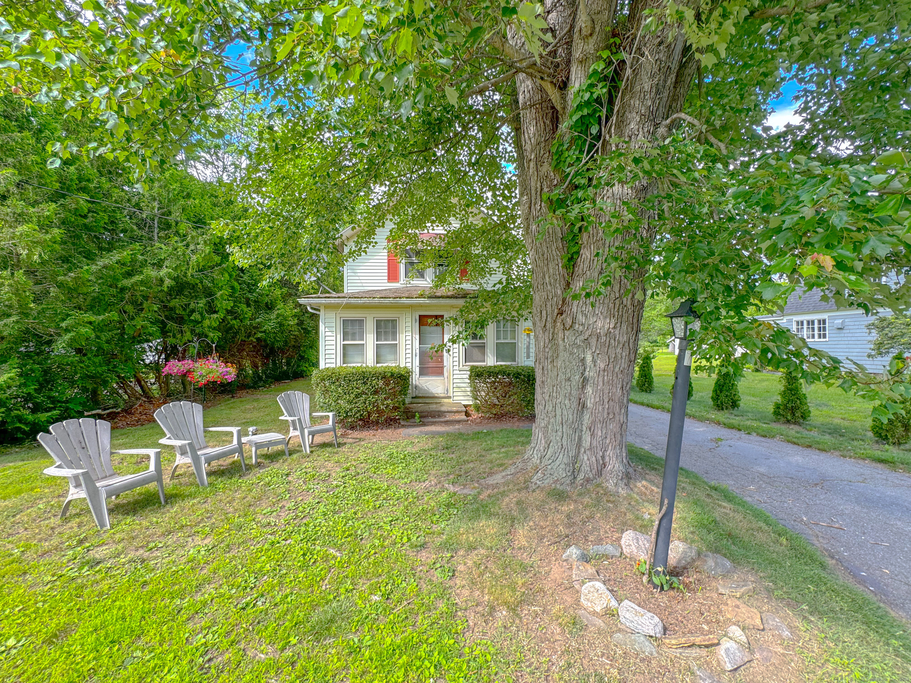 a view of a house with backyard porch and sitting area