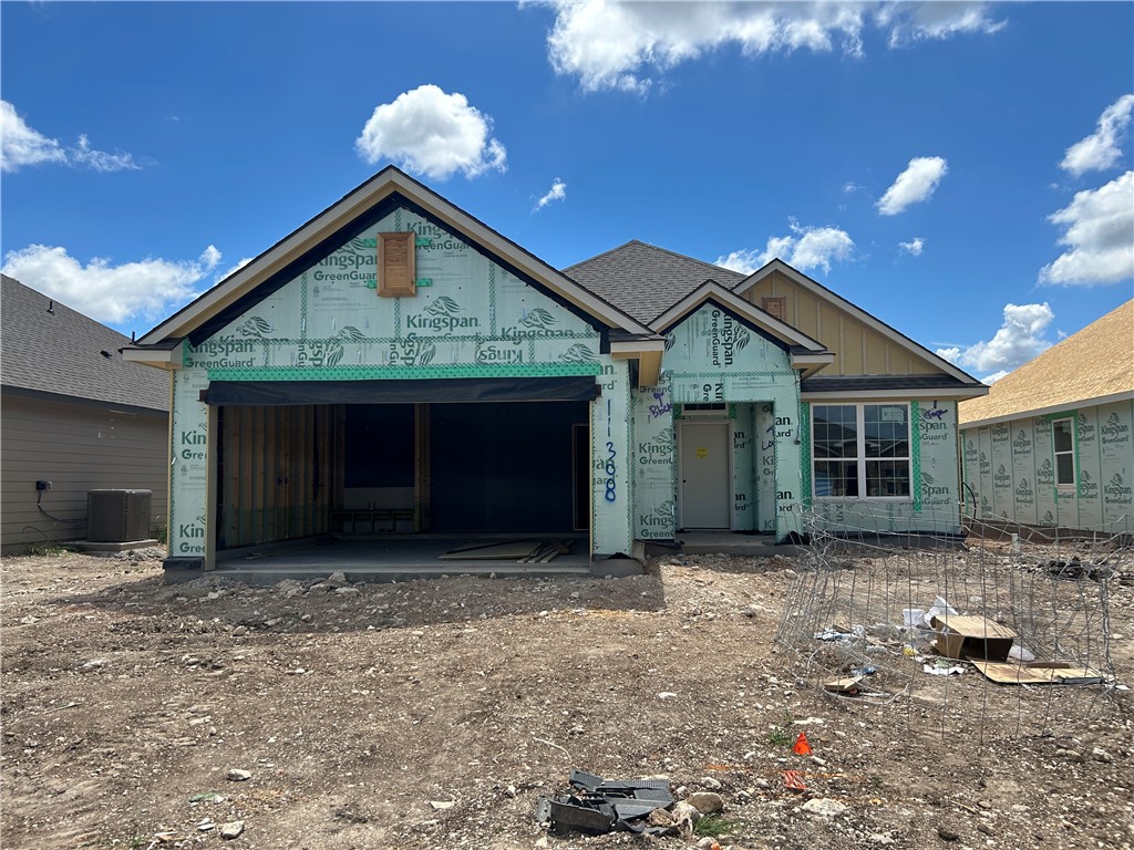 a view of a house with a yard and garage