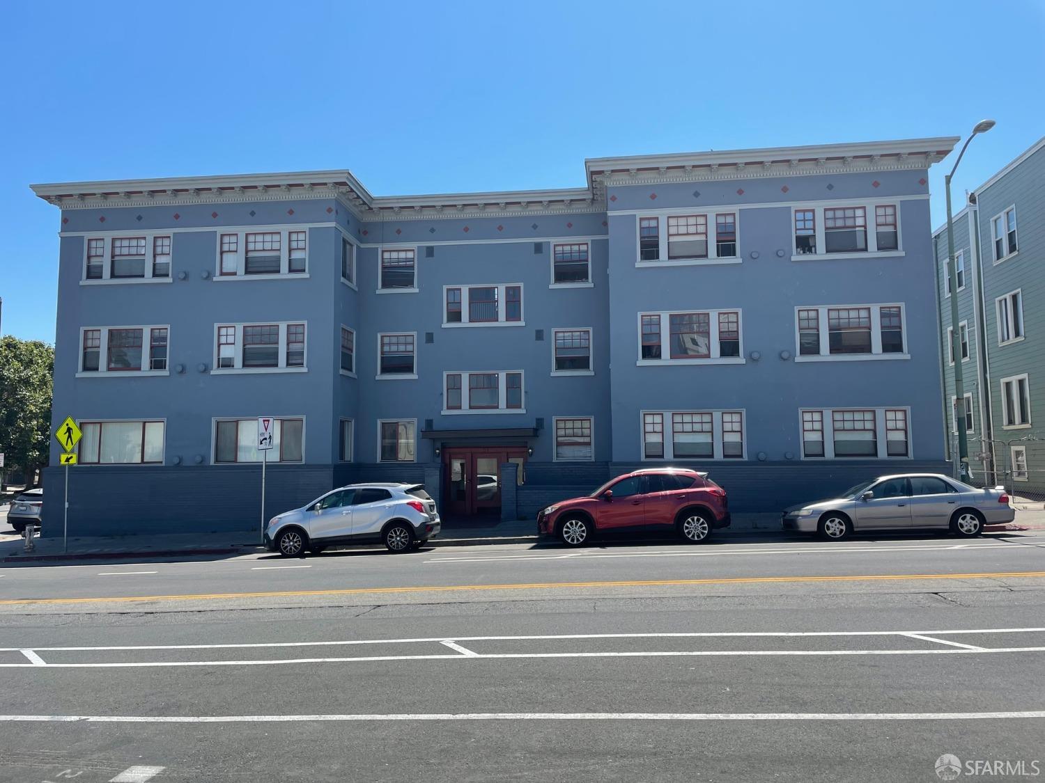 a couple of cars parked in front of a building