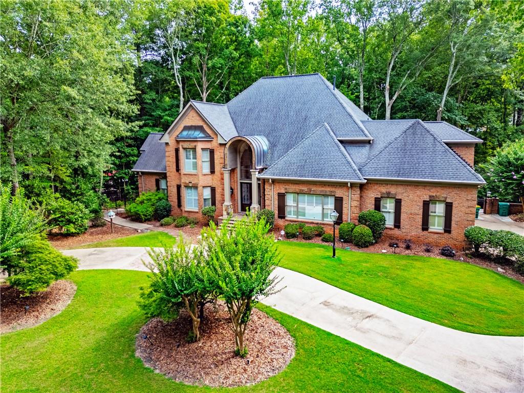 a house that has a lot of plants and trees in the background