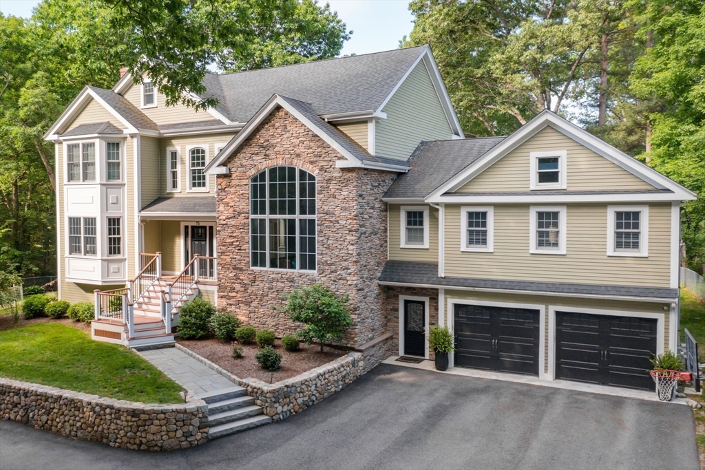 a front view of a house with a yard and garage