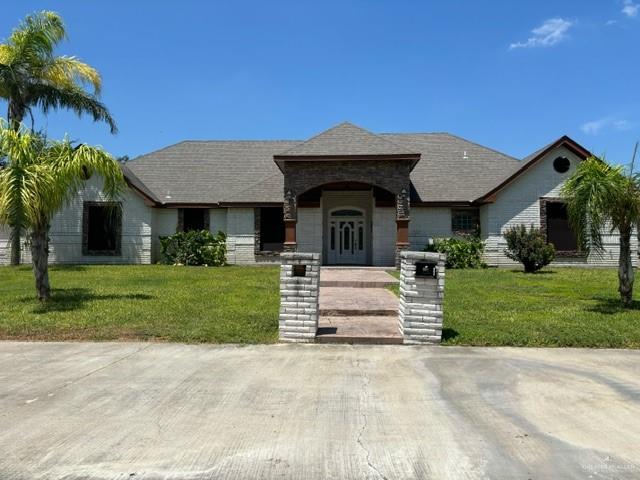 a front view of a house with a garden