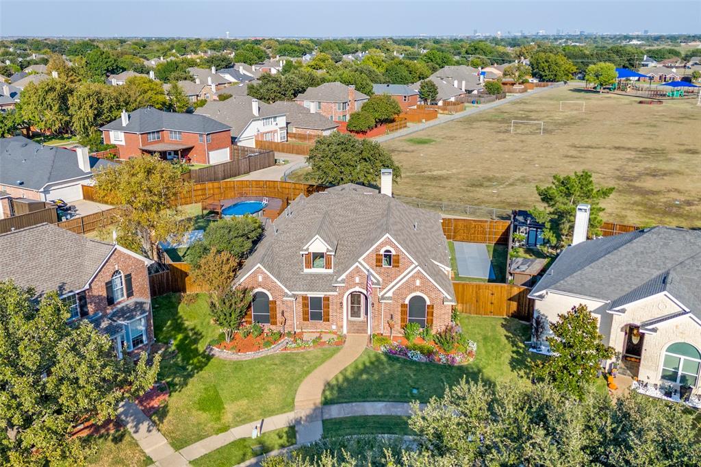 an aerial view of multiple houses with yard