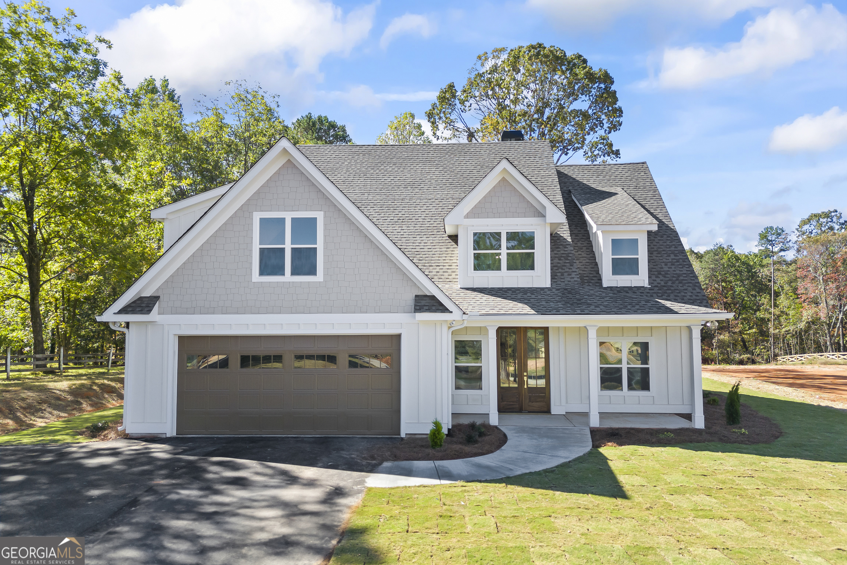 a front view of a house with a yard and garage