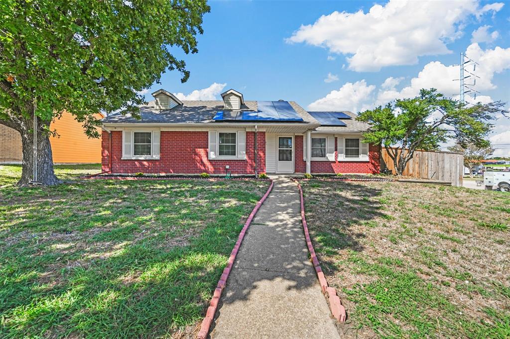 a front view of a house with a yard and trees