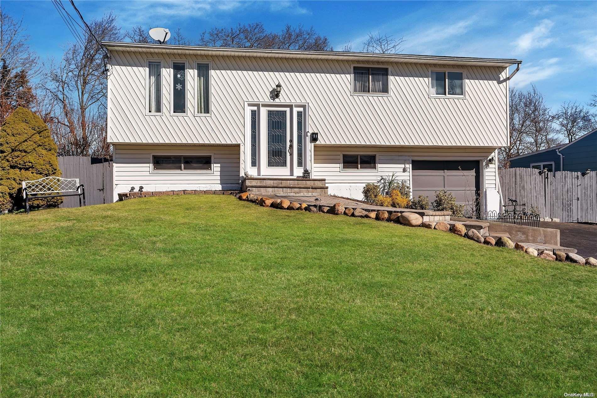 a view of a house with a yard and sitting area