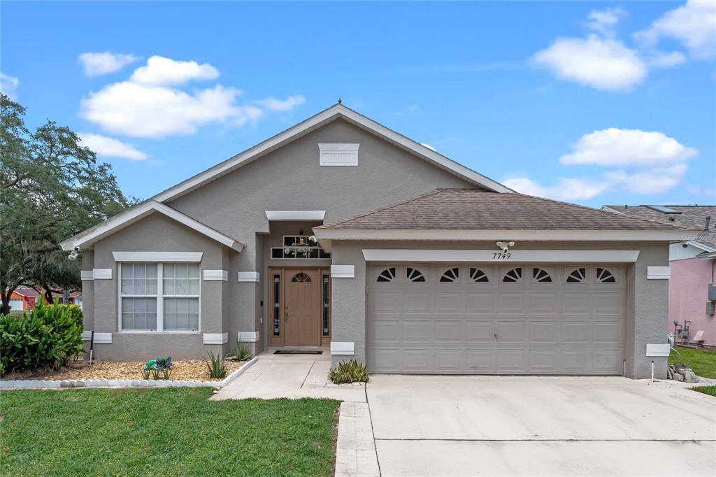 a front view of a house with a yard and garage