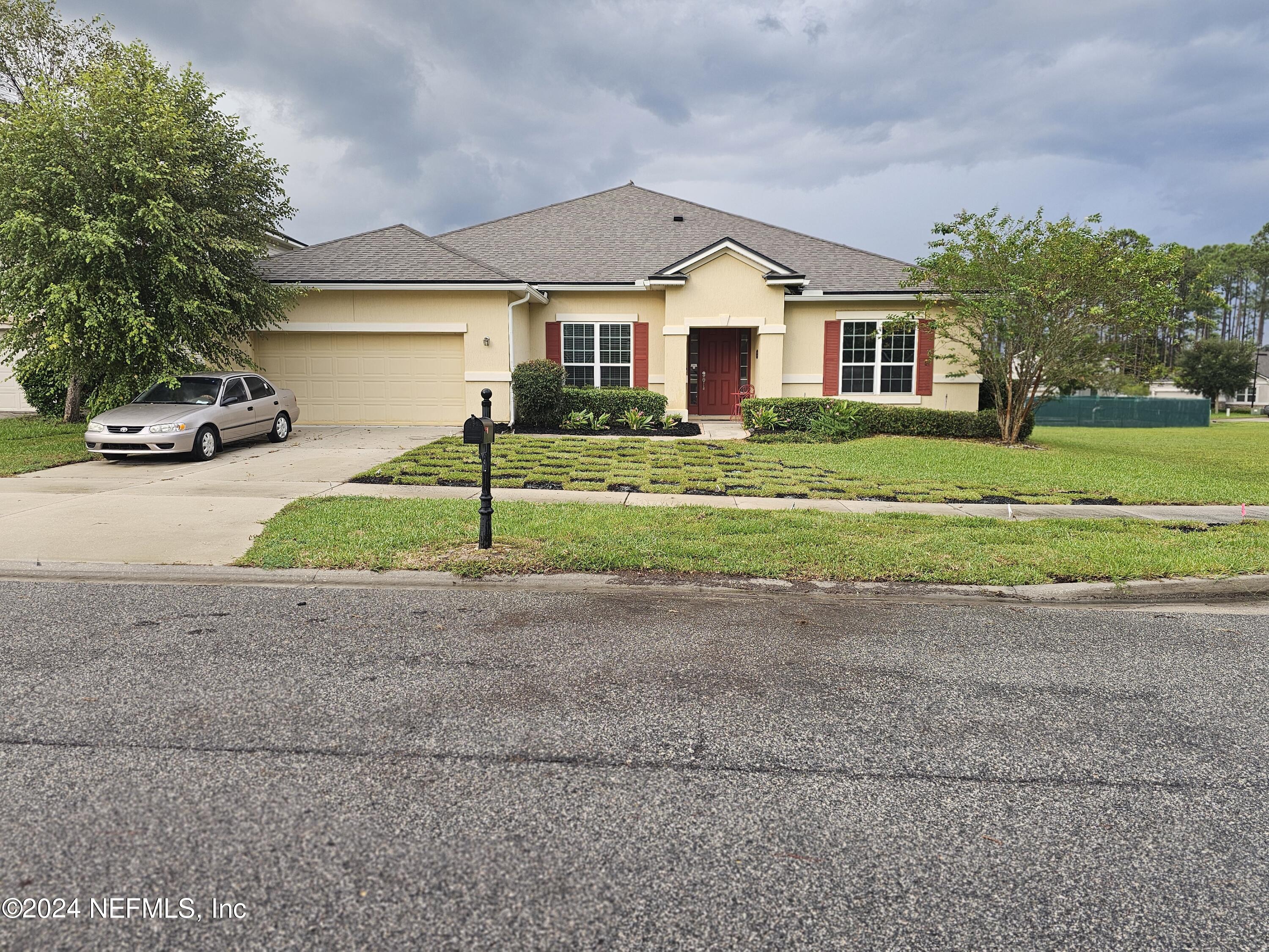 a front view of a house with a yard and garage