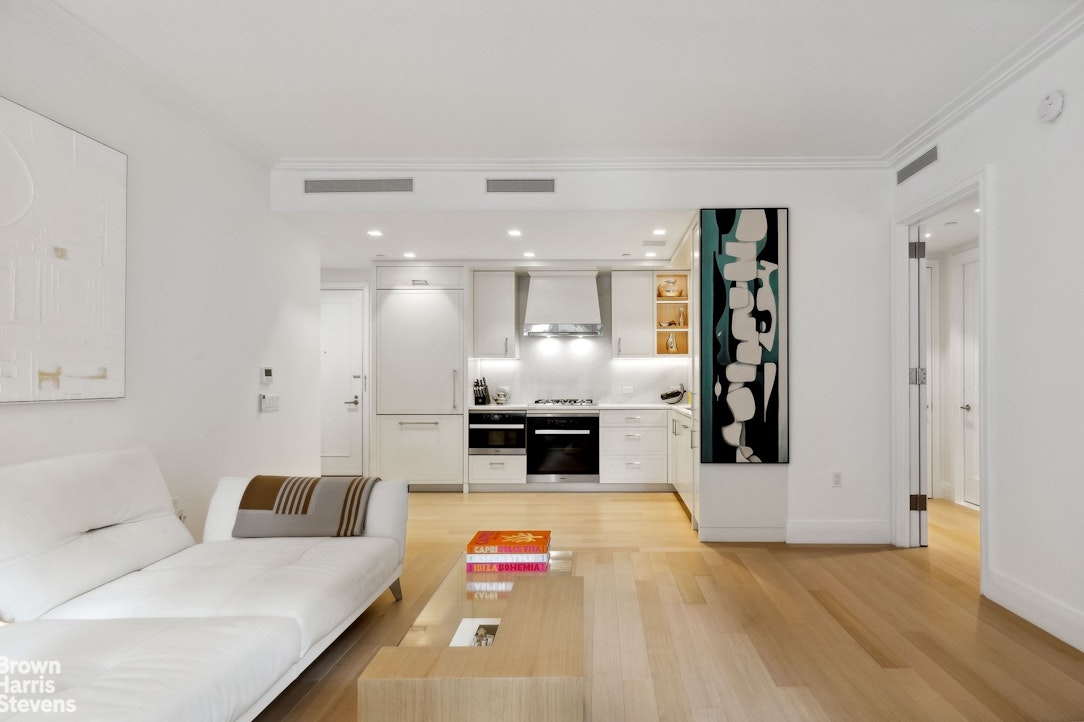 a large white kitchen with a large window