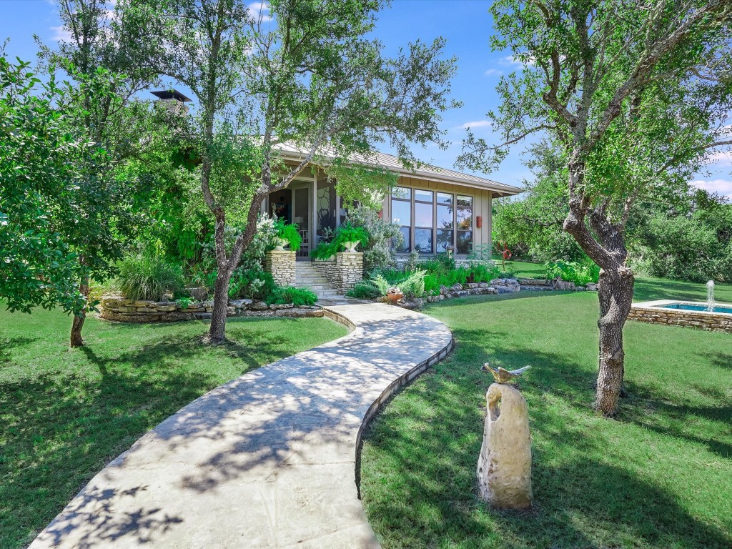 a front view of a house with a yard table and chairs