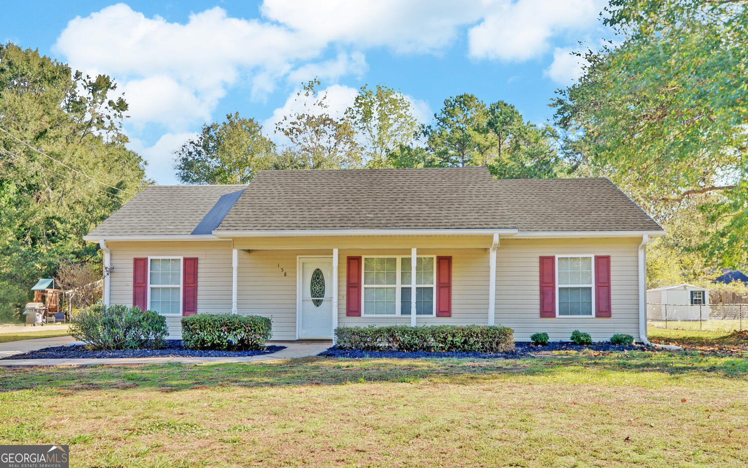 a front view of a house with a yard and swimming pool