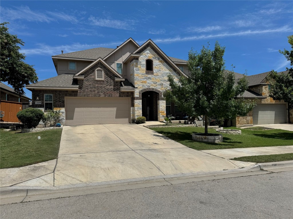 a front view of a house with a yard