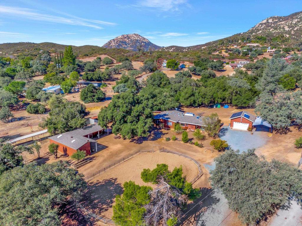 an aerial view of a houses with a swimming pool