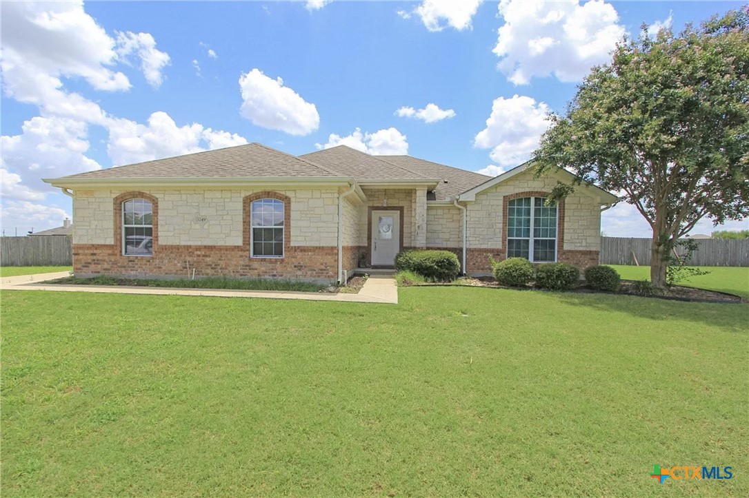 a front view of house with yard and green space