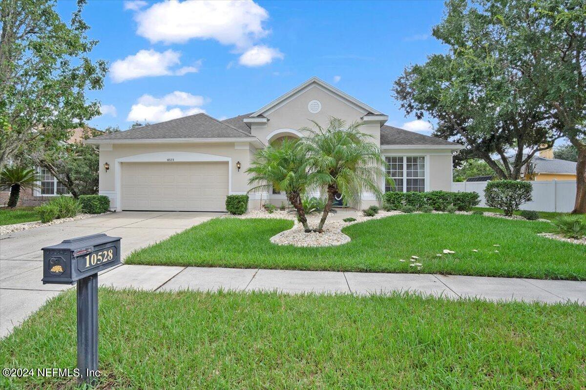 a front view of a house with a yard and garage