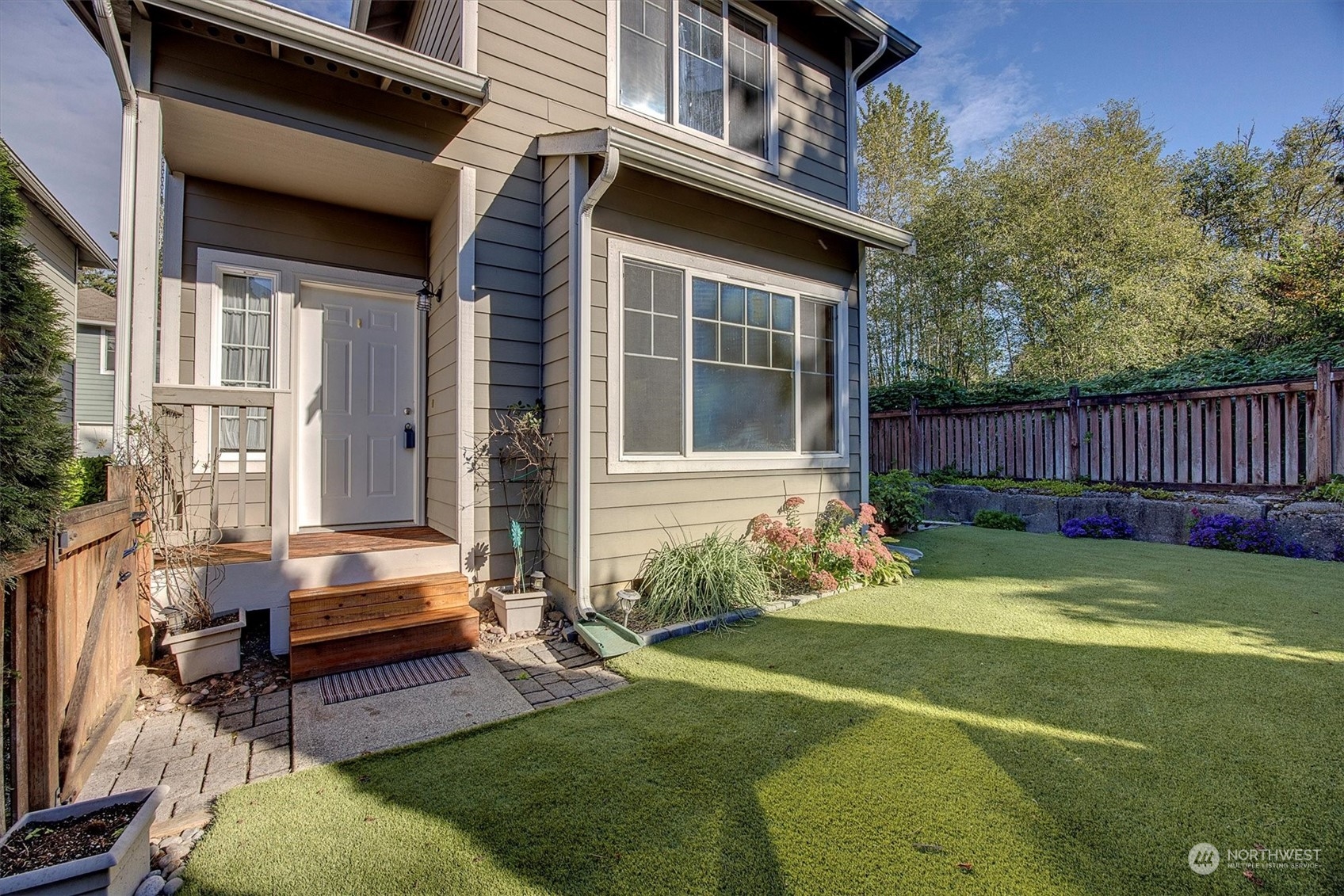 a view of a house with backyard and sitting area