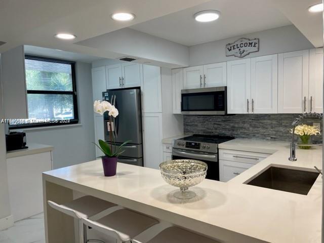 a kitchen with a sink a stove and cabinets