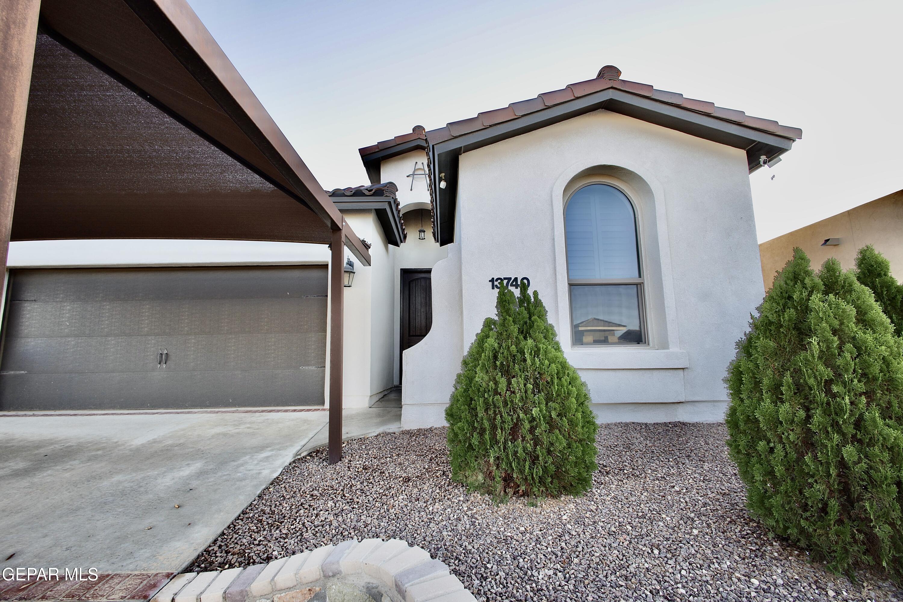 a front view of a house with garden