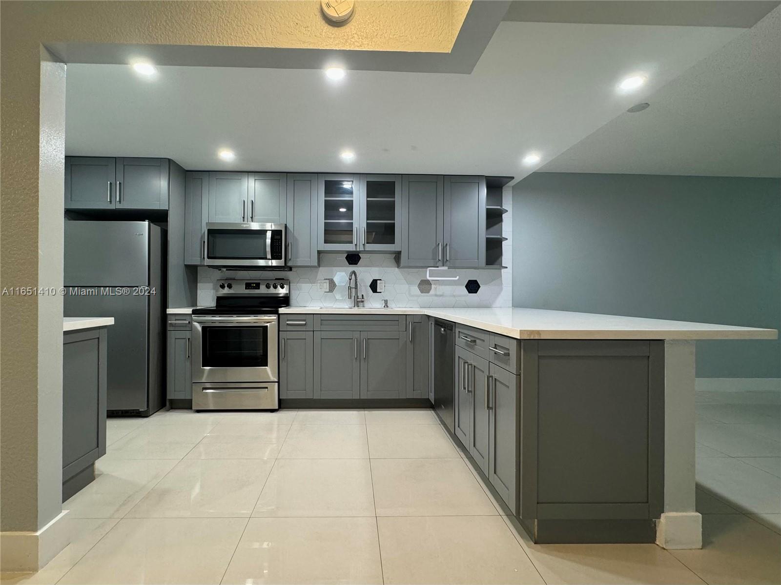 a kitchen with stainless steel appliances a sink and counter top