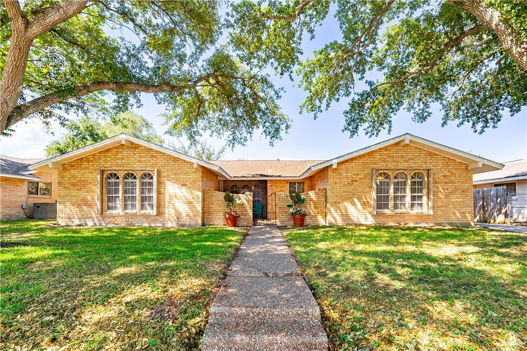 a front view of a house with a yard and porch