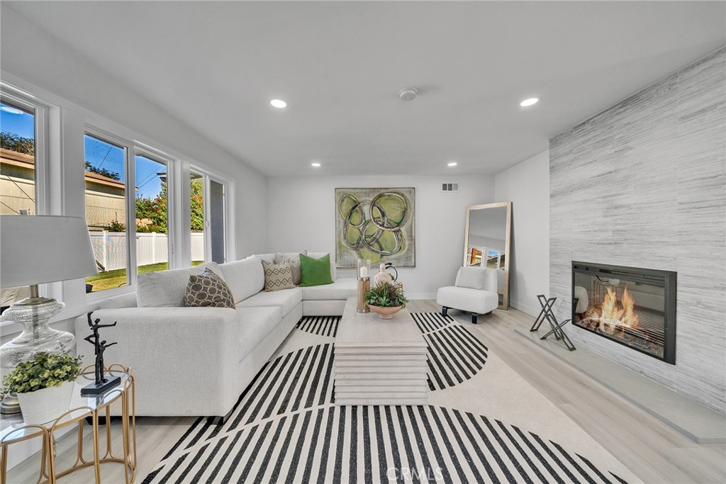 a living room with furniture and a fireplace