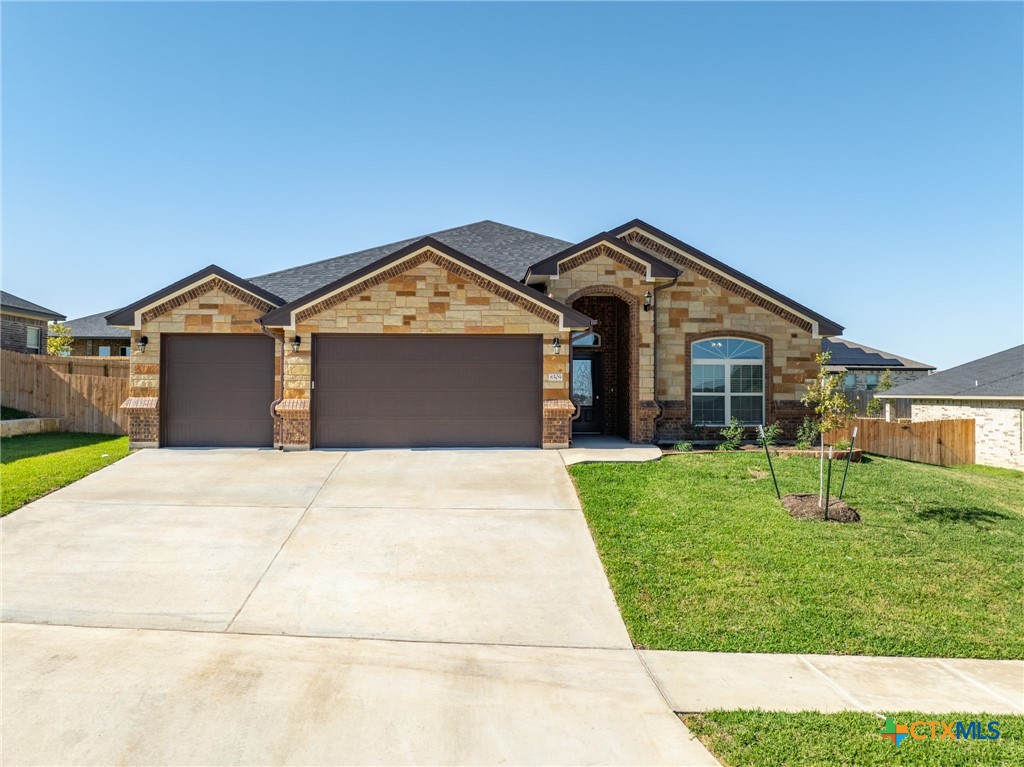 a front view of a house with a yard and garage