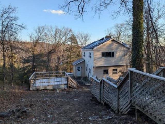 Rear view of property featuring a wooden deck