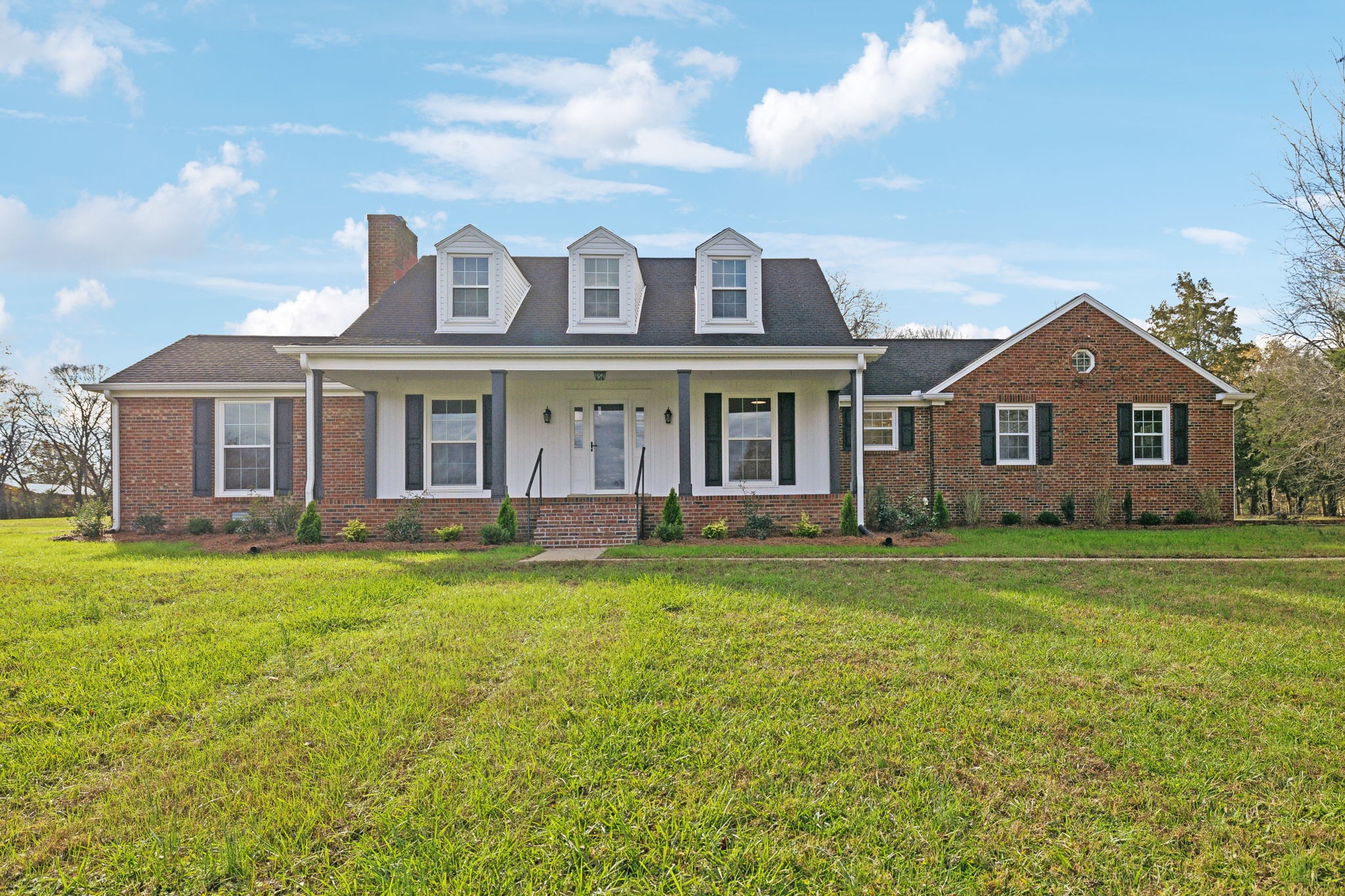 a front view of a house with a garden