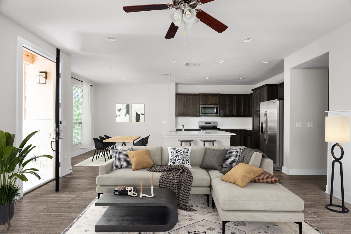 a living room with furniture and kitchen view