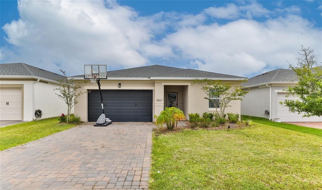 a front view of house with yard and outdoor seating