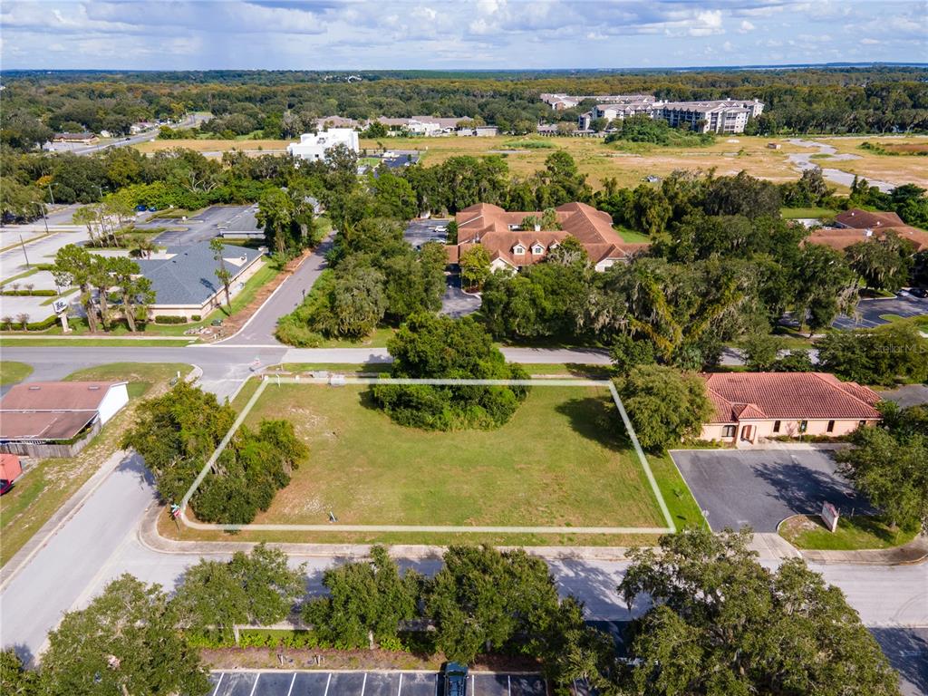 an aerial view of residential houses with outdoor space and swimming pool