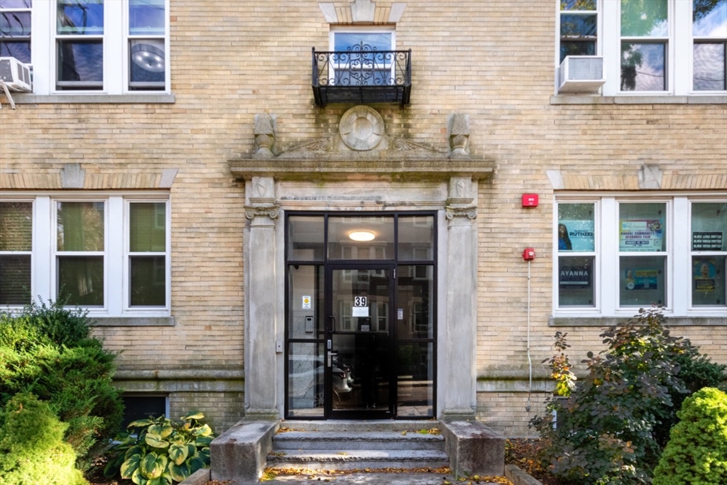 a view of brick house with large windows