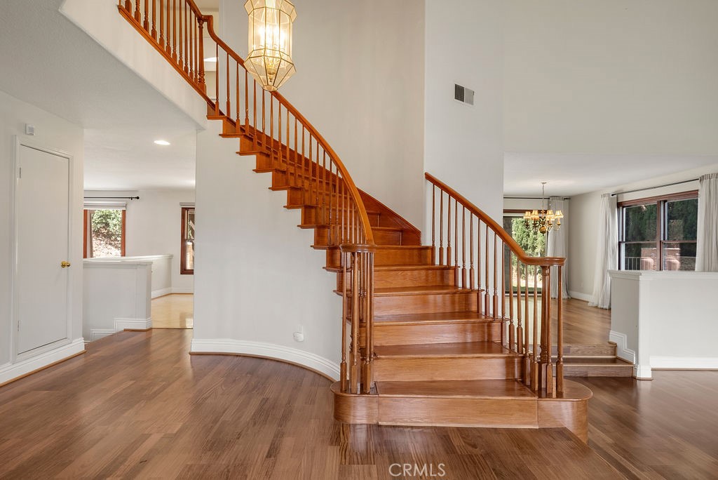 a view of entryway and hall with wooden floor