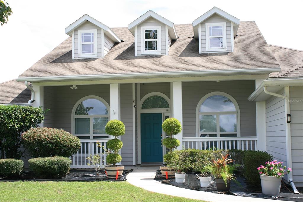 a front view of a house with garden