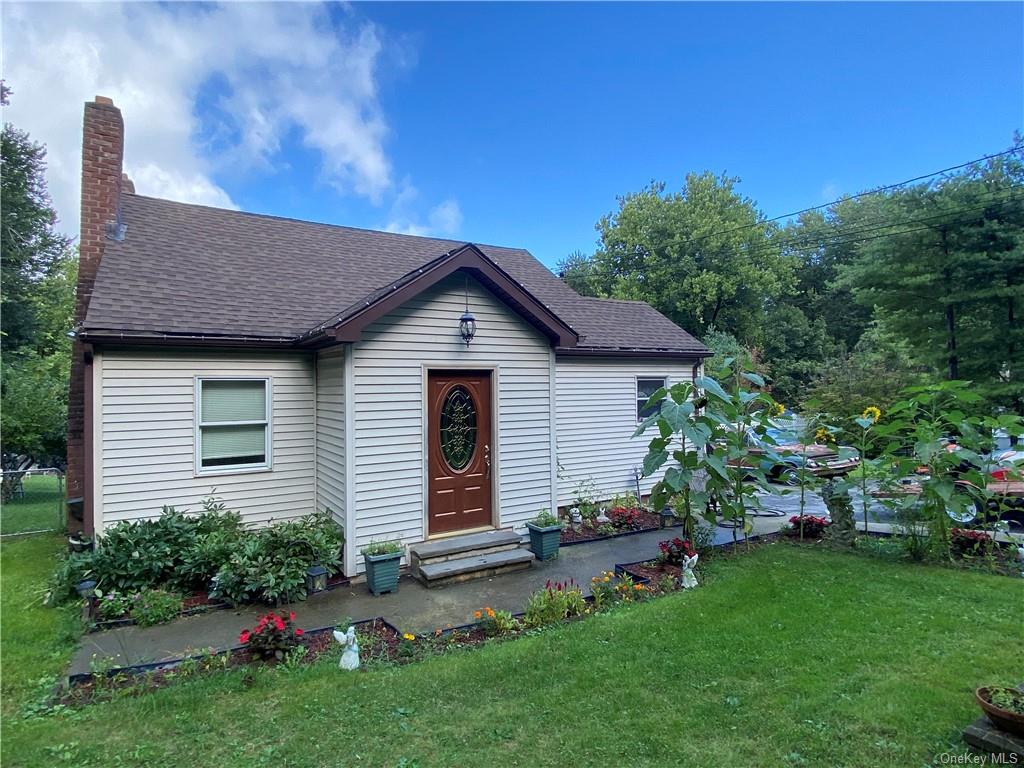 a front view of a house with a garden