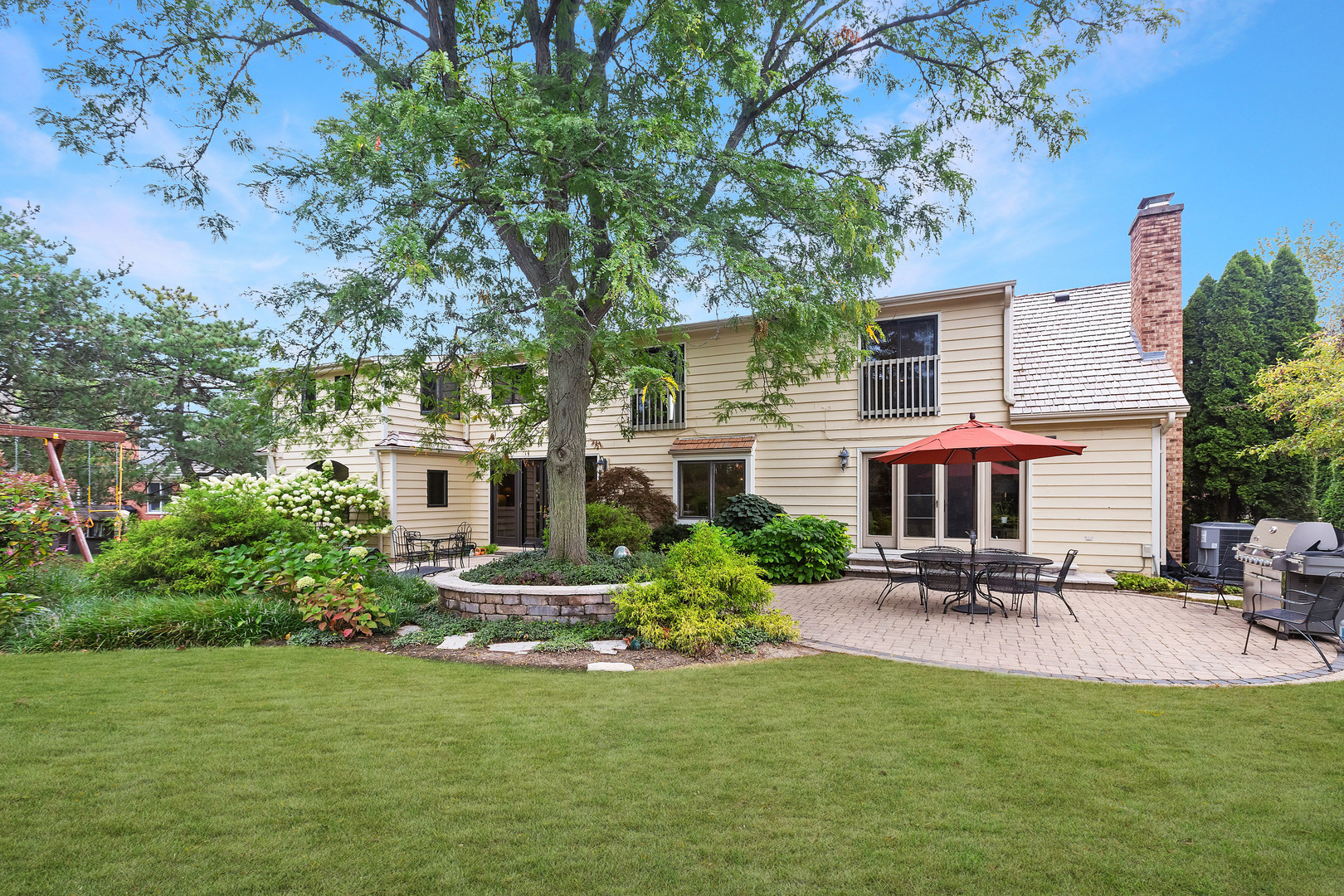 a front view of house with yard and trees