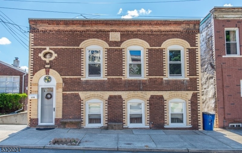 a front view of a house with large windows