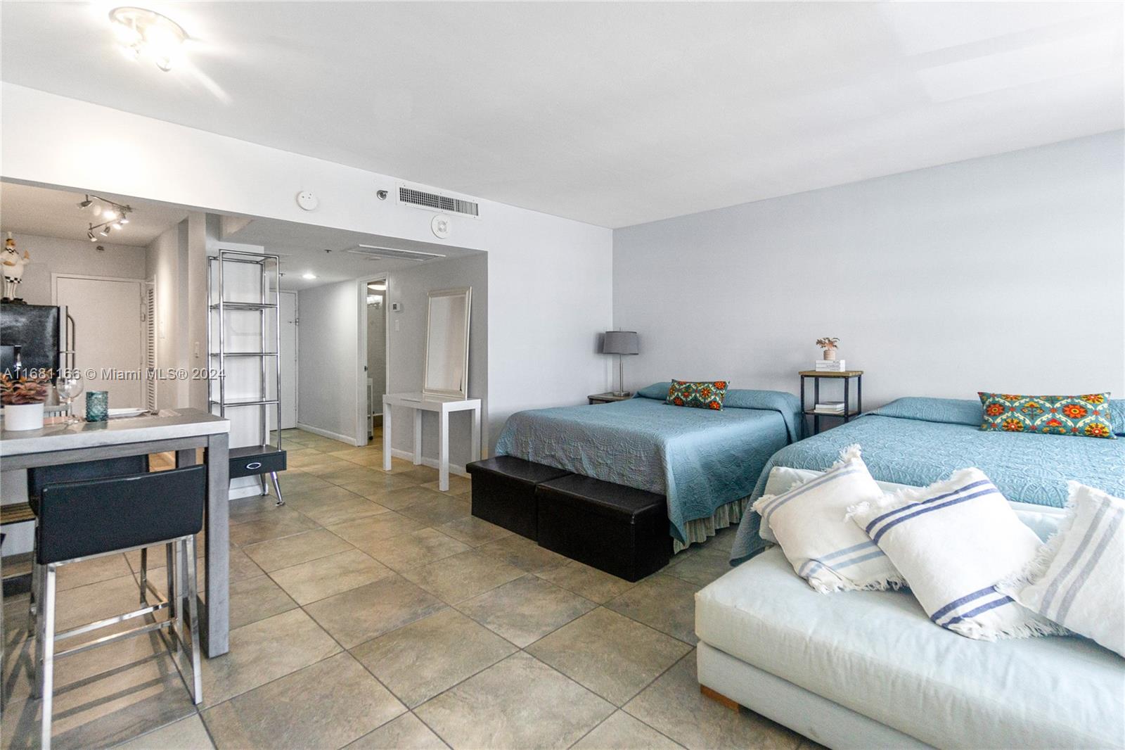 a bedroom with a bed and a view of kitchen