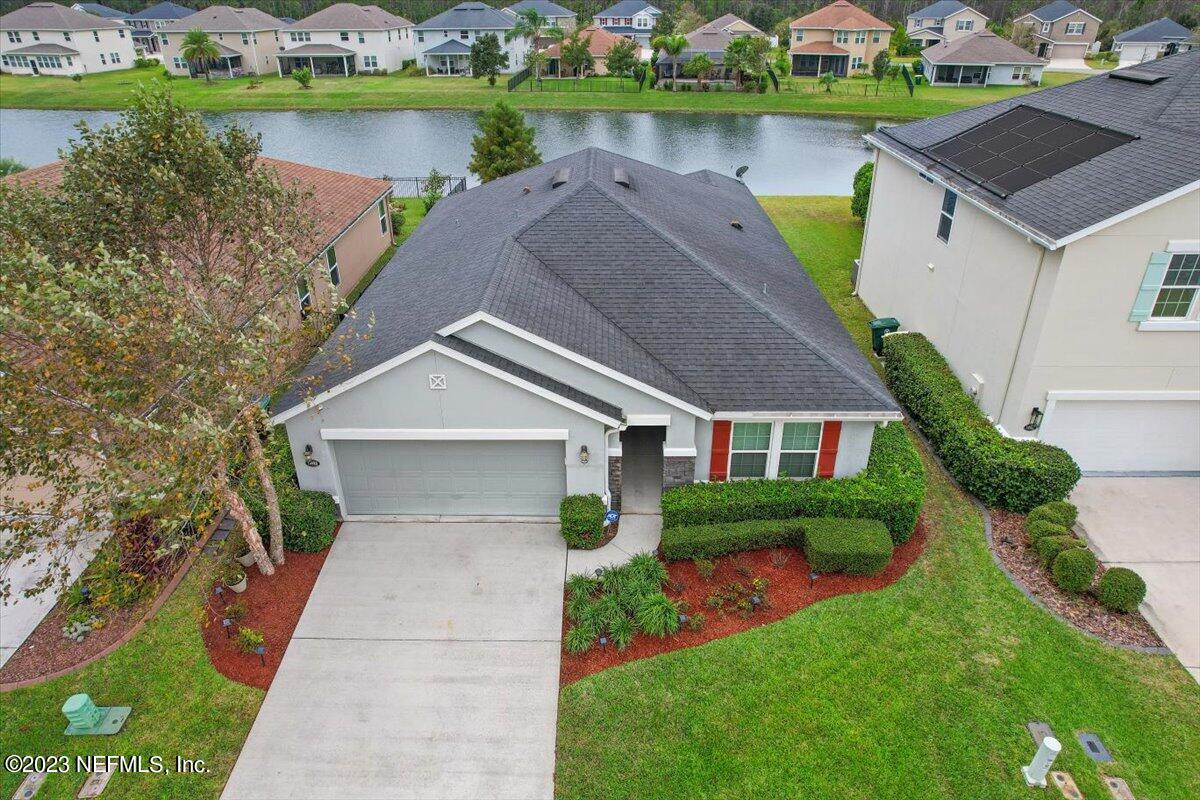 a aerial view of a house with garden and lake view