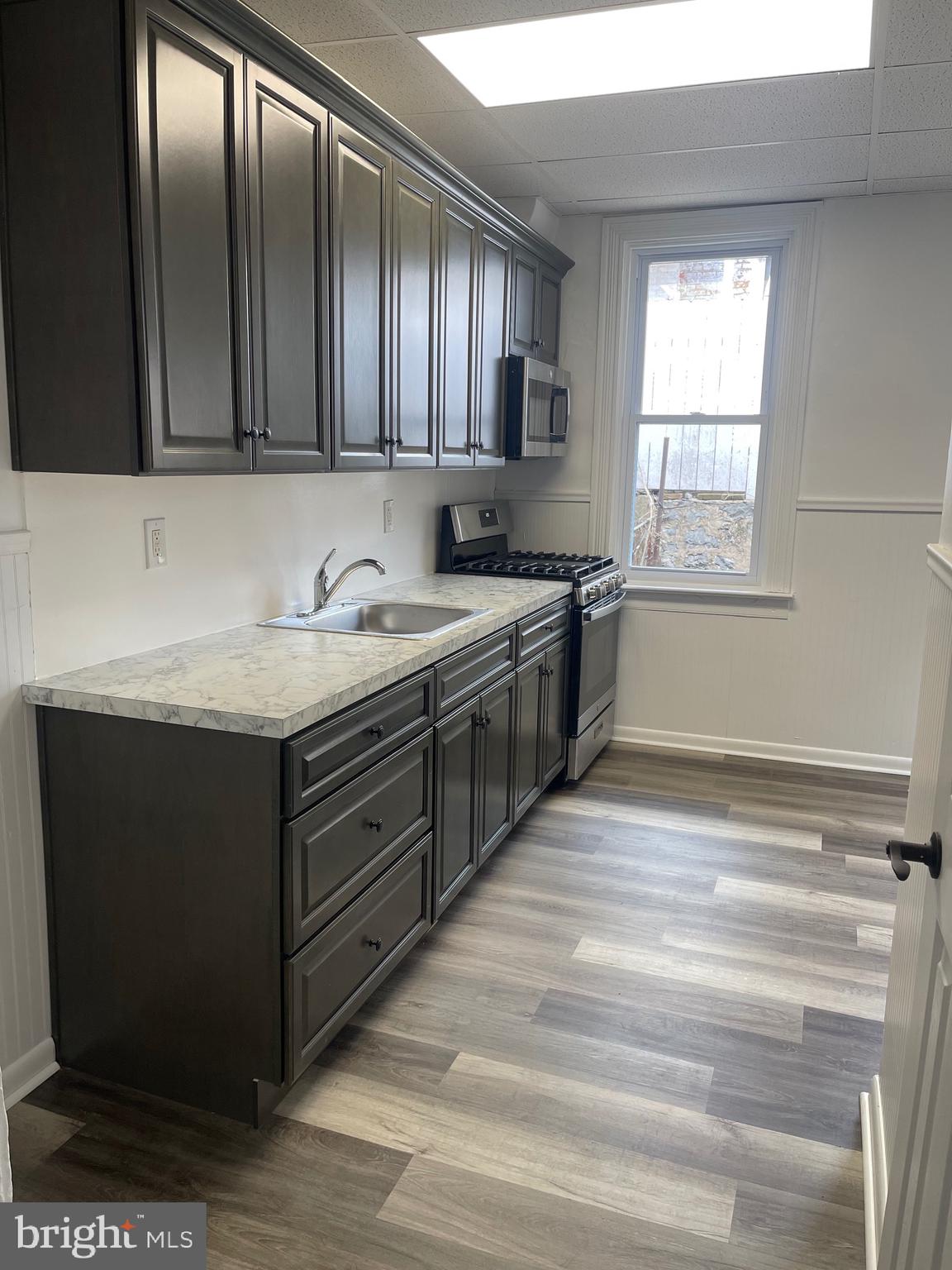 a kitchen with stainless steel appliances granite countertop cabinets and window